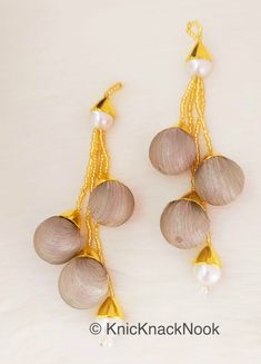 two pairs of earrings with pearls on them