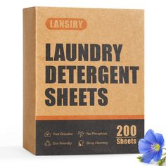 a box of laundry detergent sheets next to a blue flower