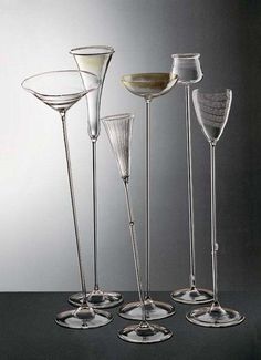 four wine glasses sitting on top of a table