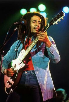 bob marley playing his guitar on stage at the concert in london england - stock image