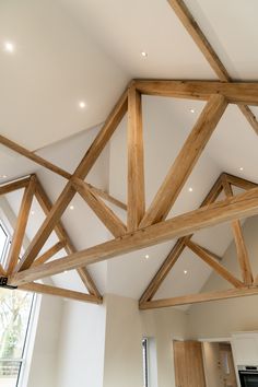 an open room with wooden beams and white walls