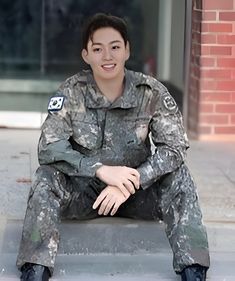 a woman in uniform sitting on the ground