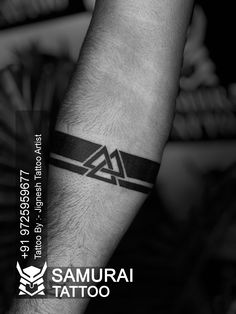 a man's arm with a black and white tattoo design on the left forearm