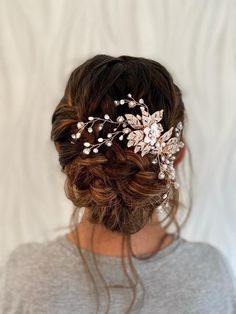 a woman wearing a hair comb with flowers on it