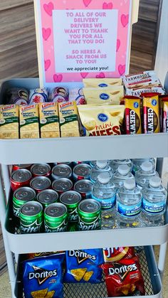 a cart filled with snacks and drinks next to a sign