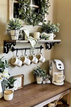 coffee cups and plants are on the shelf