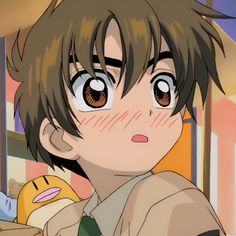 an anime character with brown hair and big eyes looking at something in front of him