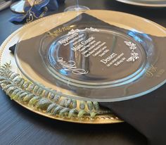 a glass plate with a poem on it sitting on a table next to other plates