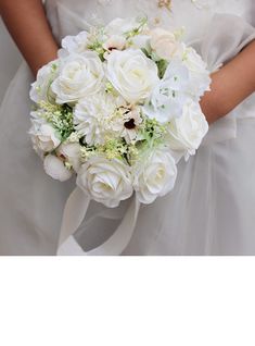 a bride holding a bouquet of white flowers