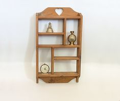 a wooden shelf with two clocks on it