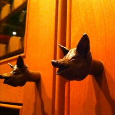 two deer head mounted to the side of a wooden door