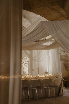 the table is set up with white linens and candles for an elegant wedding reception