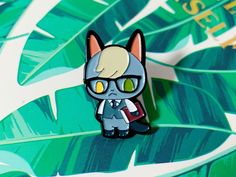 a pin with a cat wearing glasses on it