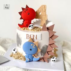 a birthday cake with an image of a dragon and other animals on it's side