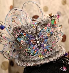 🎩 Her name is "Um" from Umbridge (when you know you know) Small Silver Top Hat on a Headband, adorned with gears, jewels,wired ribbon & butterfly & hatter glitter    My Punkadelic Headbands are One of a kind Frilly, Feathery, Fancy, Flowy & Funtastic and is sure to Punky up your Funky as you Gear up for any Event or Party!  ⚙️Every Punkadelic Item is One-Of-A-Kind, Handcrafted, Unique & Eclectic. Each Imperfectly Perfect Creations is Made with ❤️ &  My 🤲🏻.   🗝Please feel free to message me w Handmade Steampunk Festival Costume Hats And Headpieces, Steampunk Adjustable Top Hat For Festivals, Steampunk High Crown Festival Hat, Luxury Adjustable Steampunk Hat, Steampunk Top, Steampunk 4" Top Hat, Steampunk Top Hat, Pretty Hats, Silver Tops