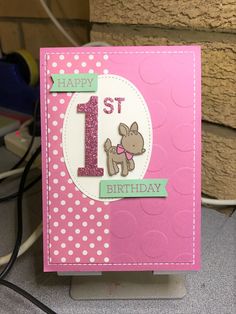 a pink birthday card with a dog on it and the number 1 is for 1st birthday