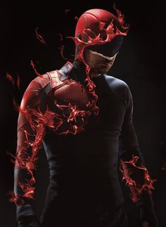 a man in black and red is wearing a helmet with flames coming out of it