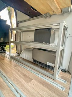 the interior of a camper van with its bed and televisions on it's sides