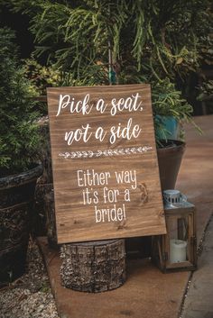 a wooden sign that says pick a seat, not a side either way it's for a bride