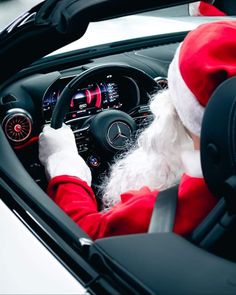 santa claus is driving his car with the steering wheel down