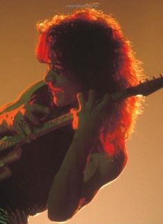 a woman with red hair holding a guitar