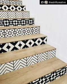 some black and white tiles are on the stairs