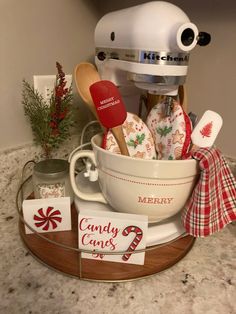 a kitchen counter with a mixer, christmas decorations and candy canes in a bowl