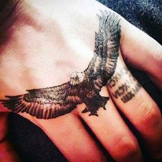 an eagle tattoo on the palm of someone's hand