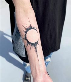 a person with a black and white tattoo on their arm that has a hole in the middle