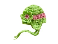 a crocheted green hat with pink flowers