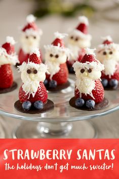 some little santa clause figurines on a glass plate