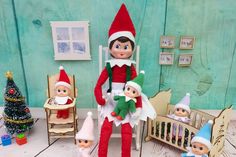 an elf is sitting in his crib surrounded by elves