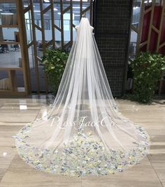 a wedding veil with flowers on the bottom