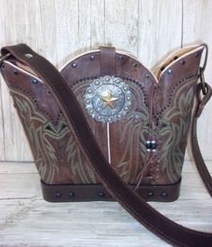 Bucket Bag Cowboy Boot Purse Hand-Crafted from a Pair of Boots No Two Alike Leather Body/Leather strap Western concho Solid Base Magnetic Closure Measures approx. 10"x13" FAQ's  Review Western Bags With Concho Detail, Western Style Bags With Concho, Western Brown Bags For Rodeo, Western Style Brown Bags For Rodeo, Western Hand Tooled Bags For Daily Use, Western Hand-tooled Bag For Daily Use, Western Style Hand-tooled Bag For Daily Use, Brown Rectangular Bag For Rodeo, Country Style Brown Bag For Everyday Use