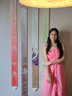 a woman standing in front of some skis hanging on the wall next to her