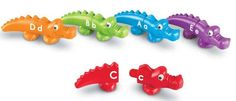 several different colored plastic alligators with the letters b, d, and f in them