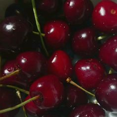 a bunch of cherries sitting on top of each other