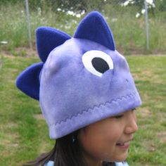 "If you love dinsoaurs, you'll love this Dino fleece hat. It's fun, warm and cozy to wear for winter and for Halloween. This hat is made with Lavender tie-dye fleece with three 3-D spikes in contrast color on top of the hat. This hat is for boys, girls and adults too (L). This hat is machine washable...just turn the hat inside out when launder.  Please also check out this dino hat in blue and green color. Sizes available: XS(18\"), M(20\"), L(22\") Machine wash cold with like colors. Gentle cycl Dino Hat, Dinosaur Hat, Clothing Projects, Kids Winter Hats, Kids Purse, Toddler Bibs, White Beanies, Brown Teddy Bear, Childrens Hats