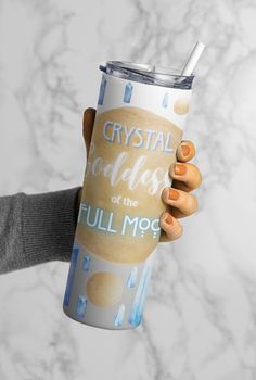 a person holding a cup with the words crystal bubbles on it