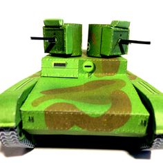 a paper model of a green camouflaged tank