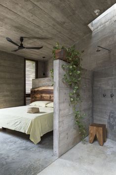 an image of a bedroom with plants growing on the wall and bed in the corner