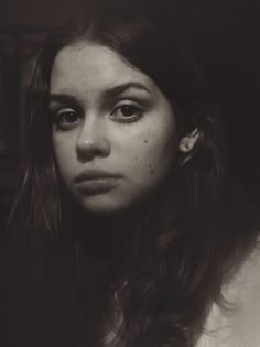 a black and white photo of a woman with freckles