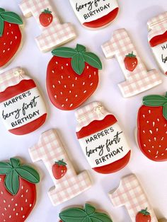 decorated cookies are arranged in the shape of strawberries and strawberrys with happy birthday written on them