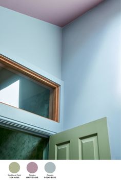 an open green door in front of a white wall with pink and blue paint swatches