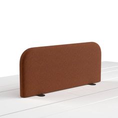 a brown headboard sitting on top of a white piano