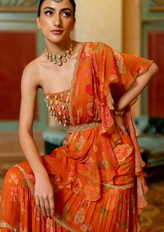 Featuring the rust pre-draped chiffon sari in our signature print , paired with kowri shell and coin detailed corset blouse. It is styled with our signature cutdana belt. Blouse With Shells, Elegant Orange Pre-draped Saree With Unstitched Blouse, Bohemian Pre-draped Georgette Saree For Designer Wear, Orange Georgette Pre-draped Saree For Party, Party Wear Orange Georgette Pre-draped Saree, Orange Indian Outfit, Indowestern Saree, Rahul Khanna, Corset Blouse