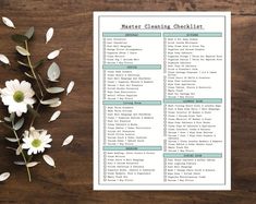 a printable cleaning checklist next to flowers on a wooden table