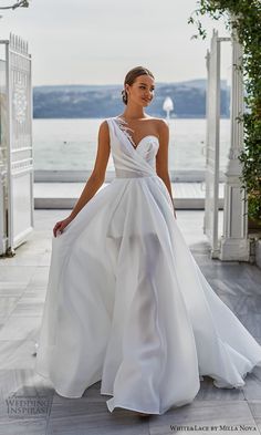 a woman in a white wedding dress is walking down the street with her hand on her hip