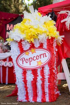 an american flag popcorn bucket decorated with yellow and red flowers