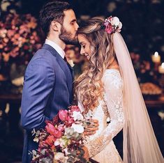 a bride and groom standing next to each other